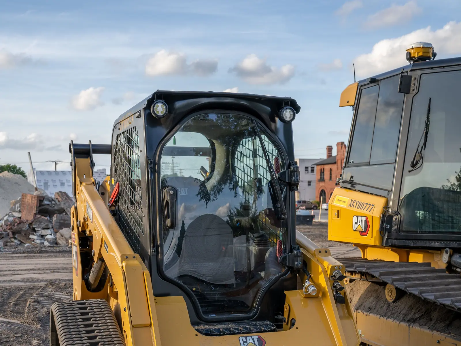Close-up of a Cat compact track loader on a dirt job site
